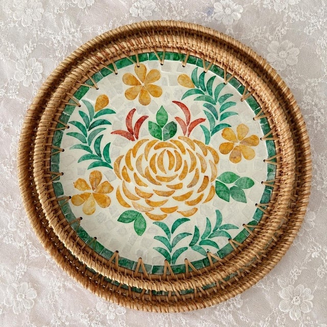 This set of two round trays is edged with natural rattan, and the surface is mosaic-inlaid with mother-of-pearl fragments,...