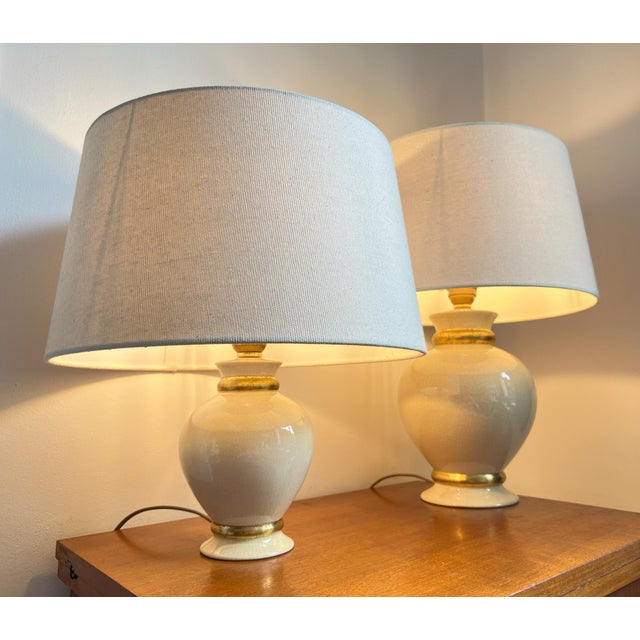 Stunning pair of vintage lamps by the renowned manufacturer 'maison le dauphin’ (france). these elegant lamps are made of...