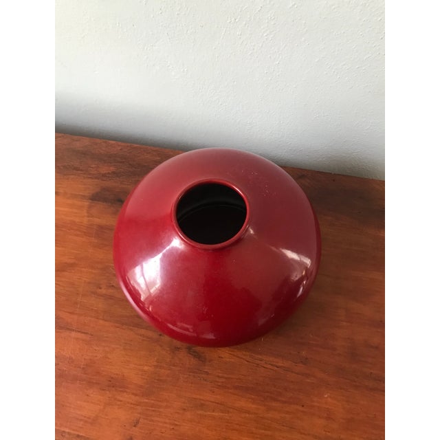 Add beautiful color to any part of your home with this uniquely shaped German pottery vase with a deep red glazed finish.