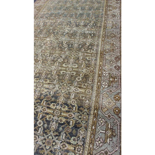 Rare Persian Malayer antique wide runner with all-over Herati design in dark gray background and variation of blue, yellow...