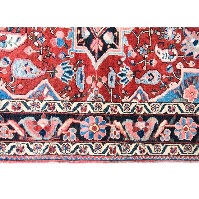 This mid-20th-century Persian Heriz rug features a bold, geometric medallion design characteristic of the Northwest...