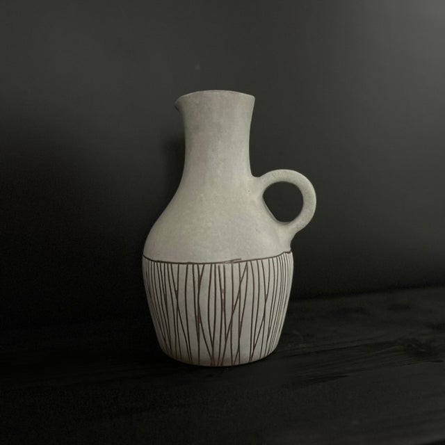 Vase / Pitcher / Jug with incised striations. Ceramic with a white-gray background. Magnificent, indescribable color, like...