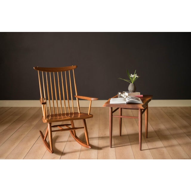 New lounge rocking chair with arms in solid walnut by George Nakashima circa 1966. This piece features signature detailed...