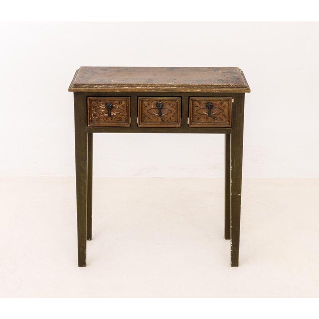 Distressed Polychrome Paint-Decorated Side Table, the giltwood top with hand-painted foliate motif above olive green base...
