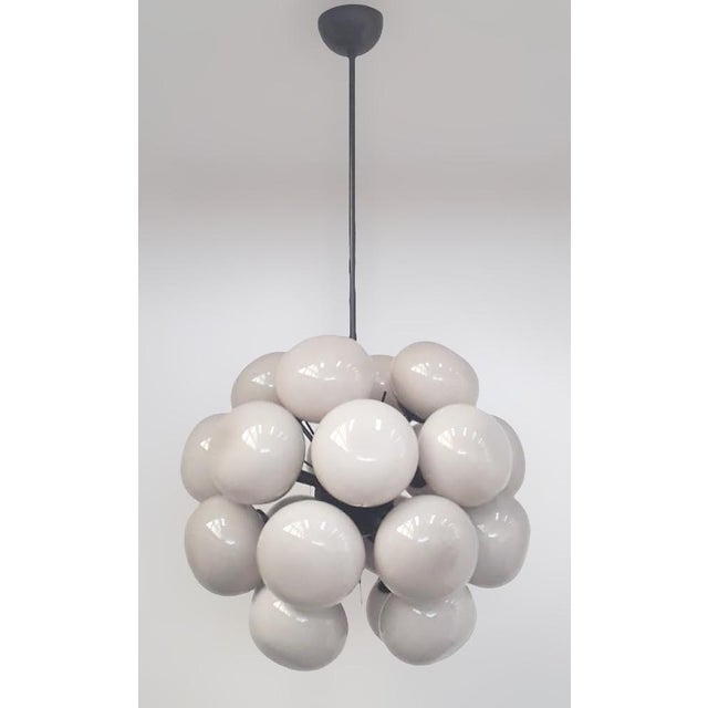 Italian sputnik chandelier with 24 cream pebble shaped Murano glass shades mounted on black powder coat finish frame /...
