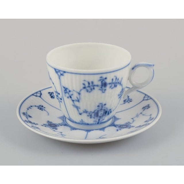 Royal Copenhagen Blue Fluted Plain. A set of four coffee cups with saucers. Model number 1/80. Dating: 1936, 1968,...