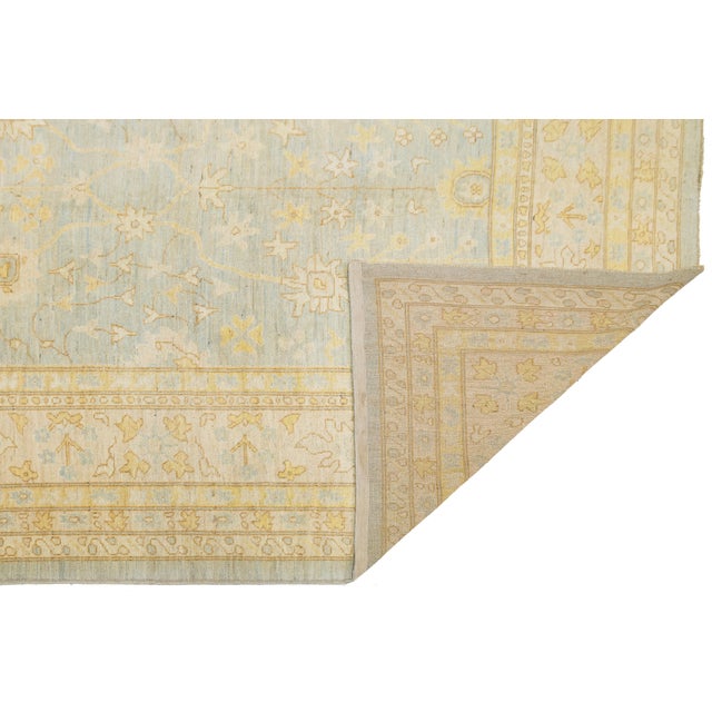 Transform your living space with this Modern Transitional Oushak Style Rug. Hand-knotted from quality wool, it features a...