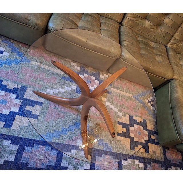 Danish circular coffee table, glass top on a finely shaped solid teak base, 1960s, excellent condition.