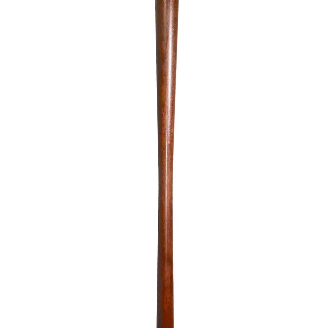 Elegant elongated wood floor lamp, Mid Century period, probably American made in the Danish style. The lamp has a center...