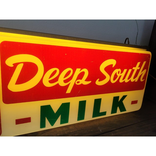 A rare piece of Southern Americana, this mid-century light-up advertising clock features the iconic "Deep South Milk"...