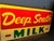 A rare piece of Southern Americana, this mid-century light-up advertising clock features the iconic "Deep South Milk"...