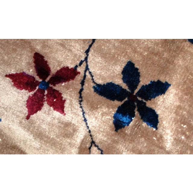This is an antique Art Deco Chinese wool rug in original condition. The rug has a very interesting background color–a...