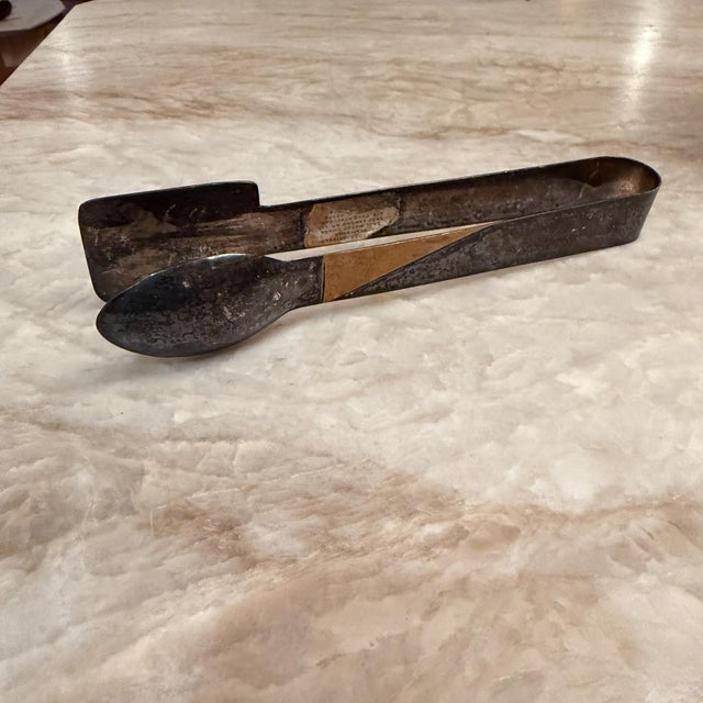 For your consideration, a sugar tongs or specialized serving utensils. While they resemble bread tongs, their compact size...