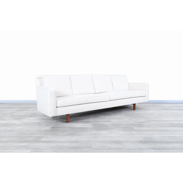 Exceptional vintage walnut sofa designed and manufactured in the United States, circa 1960s. This sofa is an excellent...