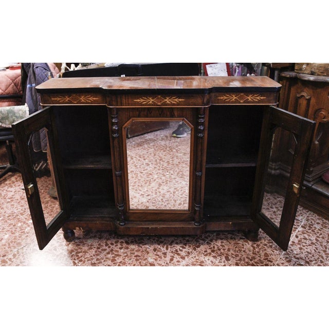 Cupboard, servante, inlaid with movable central mirror framed by turned columns tints ebony and two glass doors to destroy...