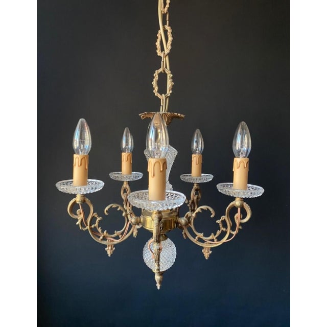 A magnificent antique chandelier. france, 20th century. the chandelier is made of brass and bronze. It’s adorned with...