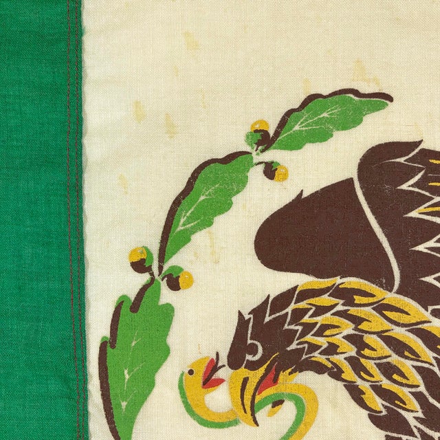 This vintage Mexican flag is made from a wool cloth with sewn panels and printed emblem visible on both sides. Please note...