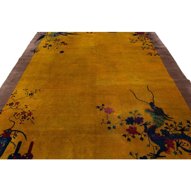 This stunning antique Chinese Art Deco rug features a vibrant Imperial Yellow field framed by a sophisticated muted...