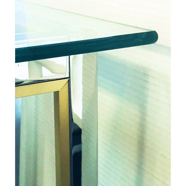A sleek mid-century modern console table. It is similar to those by Mastercraft and Italian designer Romeo Rega. It's made...