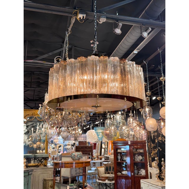 Striking Italian Murano drum chandelier featuring clear and champagne colored glass. Creates a beautiful warm glow! A...
