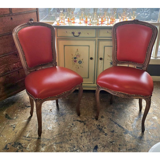 A pair of French side chairs. They were reupholstered with what I believe is a reddish Italian leather.The seats have...