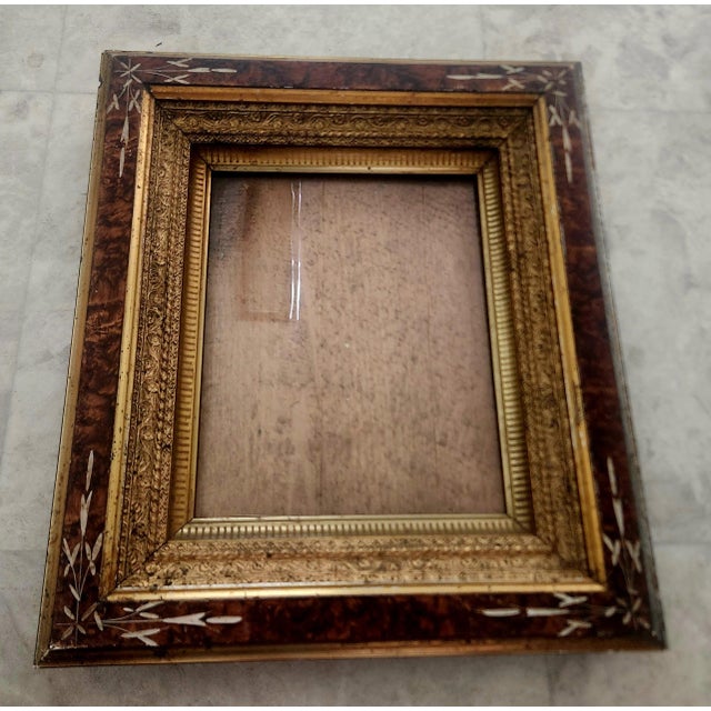 exquisite burled wood Eastlake Victorian picture frame, 1890s, carved floral design at corners, inset with layers of...