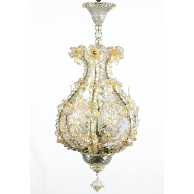 Magnificent pendant with six arms with details gold inclusions. Heads of lions are the ball falls background. Centered...