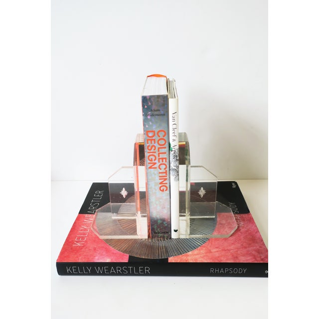 A pair of clear Lucite acrylic bookends with Modern edge and jewel-like design, in the Modern style, Midcentury Modern...