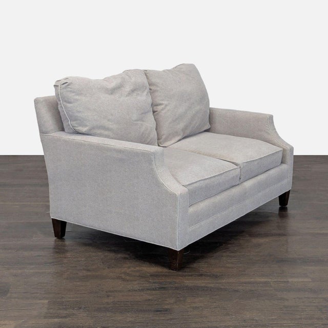 This Lexington loveseat features a clean, modern design with soft light gray fabric. The cushioned seats and backs provide...