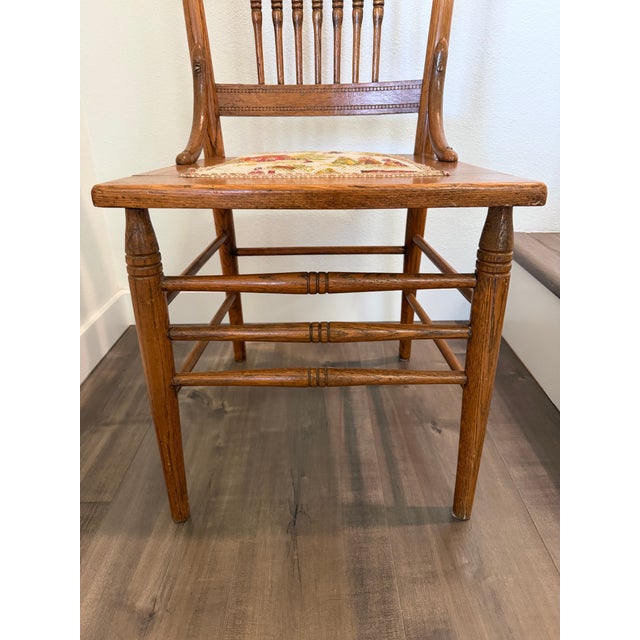 This beautiful antique American pressed-back dining chair, dating from the late 19th to early 20th century, is crafted...