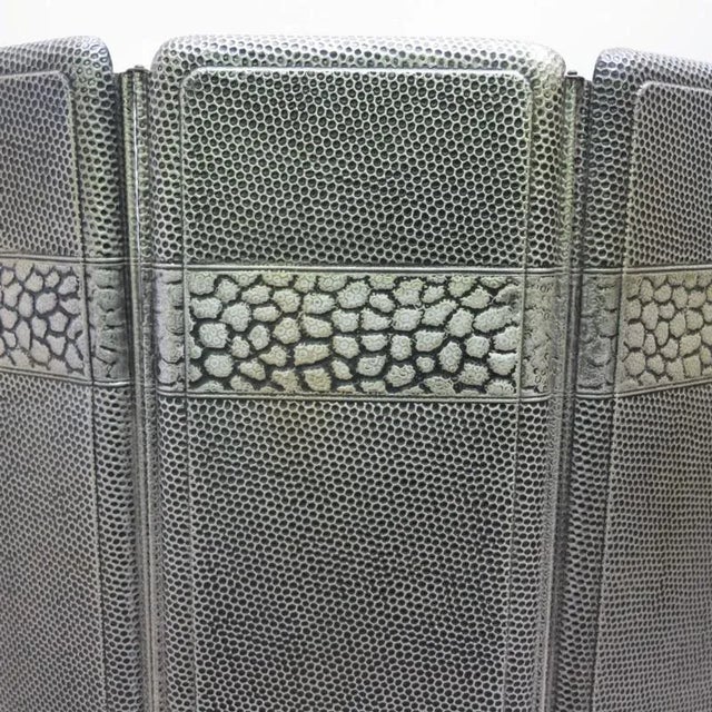 This three-part Art Deco style fire guard is from around 1930 to 1935 and is made of sheet metal with embossed motifs.