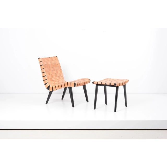 Pair of leather webbed lounge chairs with matching ottomans, designed by jens risom and manufactured by vostra (walter...