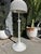 Vintage floor lamp with woven wicker construction in a white finish. Features a dome-shaped shade with open weave pattern,...