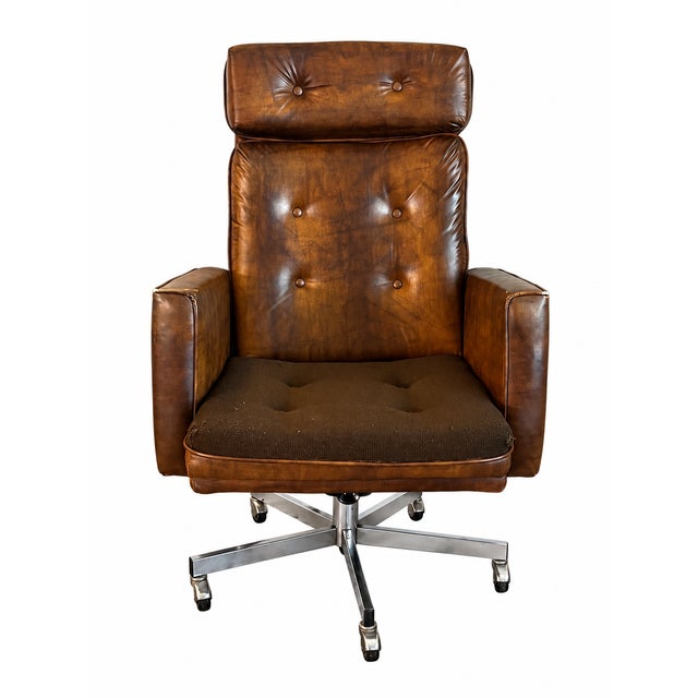 A distinctive vintage executive chair by Eck-Adams Corp., featuring a tall button-tufted back, separate padded headrest,...