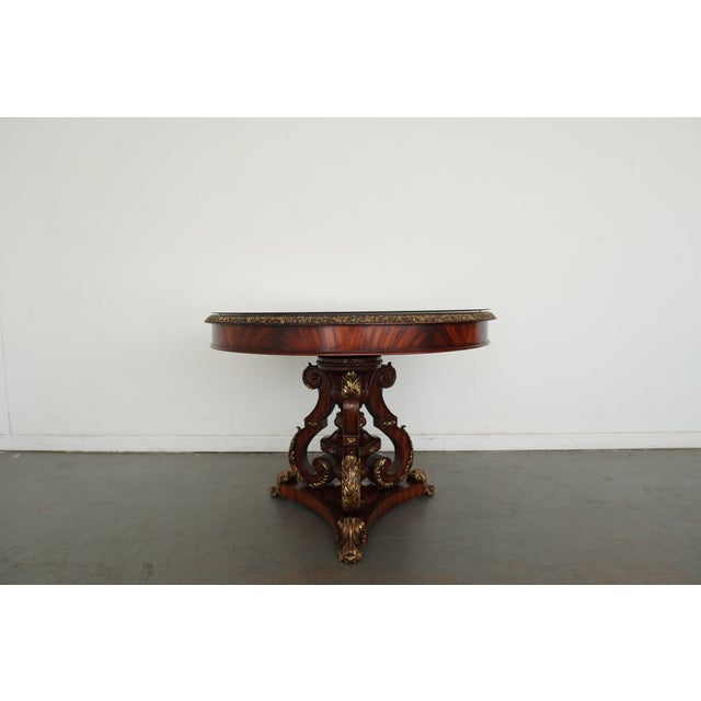 This table is crafted from rich mahogany wood, and a custom-made glass top, that speaks to timeless elegance. The round...