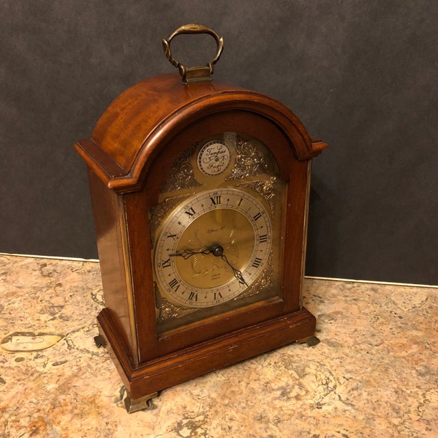 Fine English Georgian style mahogany Bracket clock. Tempus fugit face with cherubs spandrels, Roman numerals. Sold thru...