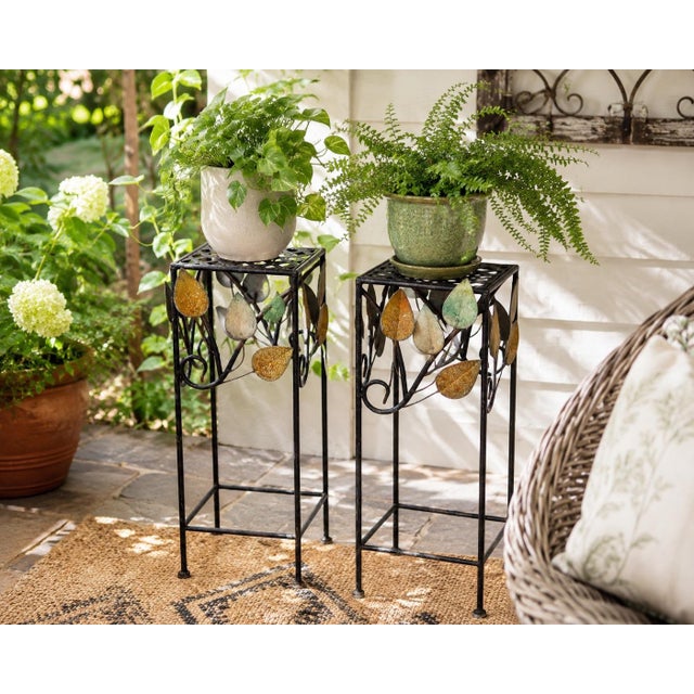 Whimsical vintage pair of Mid-Century wrought iron plant stands or decorative pedestals, circa 1960s–1970s. The slender...