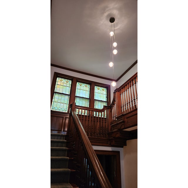 Authentic Bocci 14.5 is composed of five clear cast-glass pendants that attach to a single brushed nickel canopy. 10W...