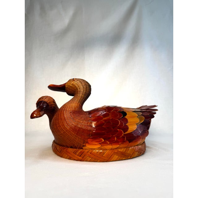 This charming vintage duck-shaped basket, likely dating to the 1970s–1980s, is crafted from tightly woven wicker or...