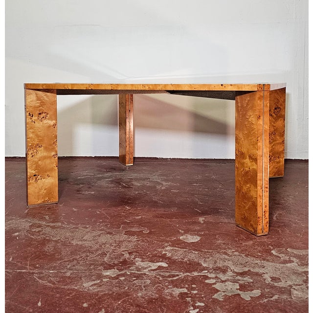Stunning and imposing table made of wood with burl wood veneer. Metal finishes and smoked tempered glass top. Good overall...