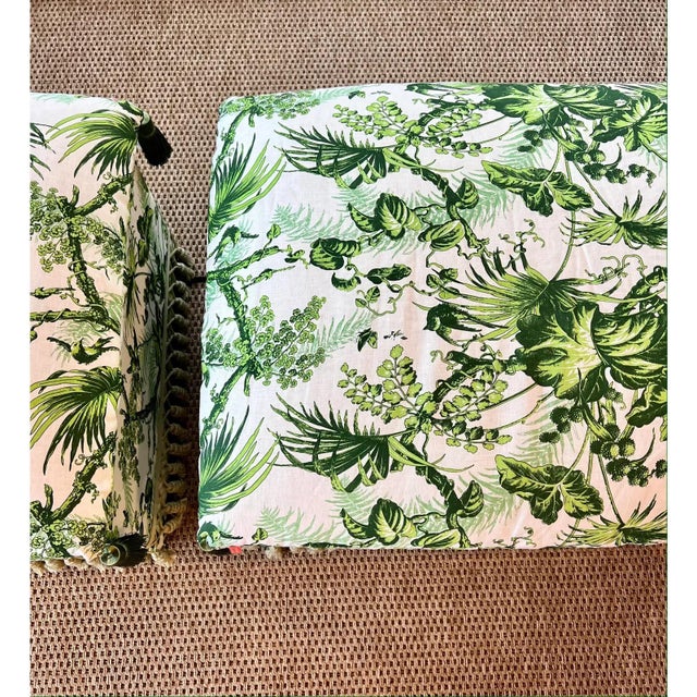 Custom-made ottoman upholstered in an elegant green botanical toile fabric featuring lush tropical motifs and refined...