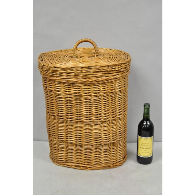 Vintage Mid Century Modern Handwoven Wicker Rattan Laundry Basket with Lid and Handle. Circa Late 20th Century....