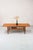 A beautiful Danish teak coffee table designed by Grete Jalk. The elongated tabletop, with its rounded corners and softly...