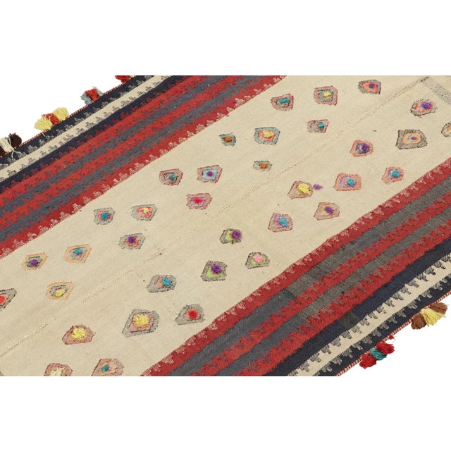 This vintage 4x6 Persian kilim is handwoven in wool, and originates circa 1950-1960. On the Design: This design remarks...
