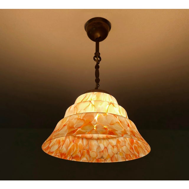 Art Deco pendant light with mottled glass shade in coral pink orange and white, burnished brass suspension Very good...
