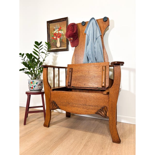 This antique oak hall bench brings real presence to an entryway. The high paneled back which once had a mirror with hooks,...