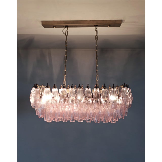 Elegant italian chandelier made from 84 beautiful murano pink glasses "poliedri". Structure in gold and brass colored...