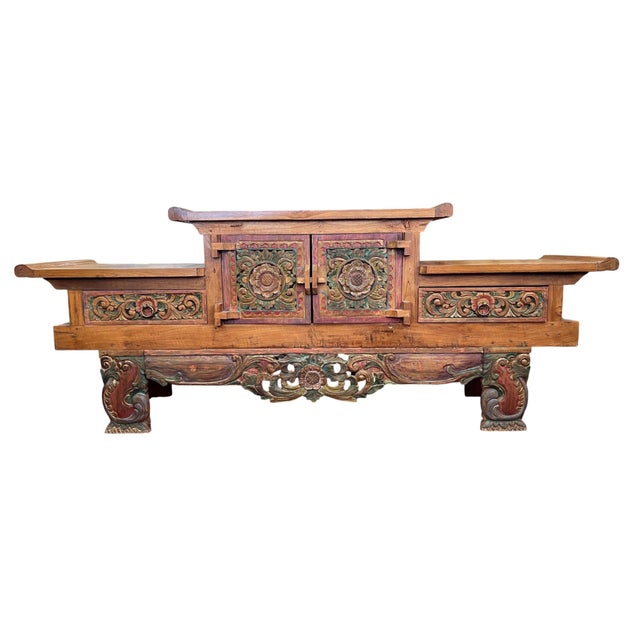 Crafted from solid, high-density teak wood, this expansive Balinese sideboard is a masterwork of 1960s Indonesian...