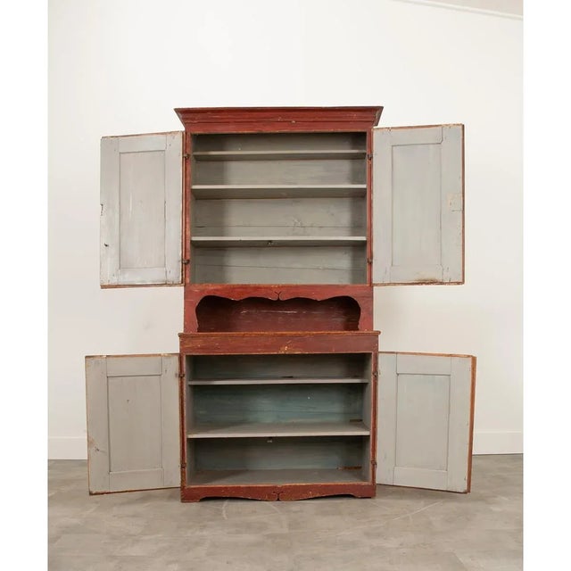 A Swedish Gustavian cabinet from the 19th century (or earlier) with its original vibrant paint palette of deep red,...
