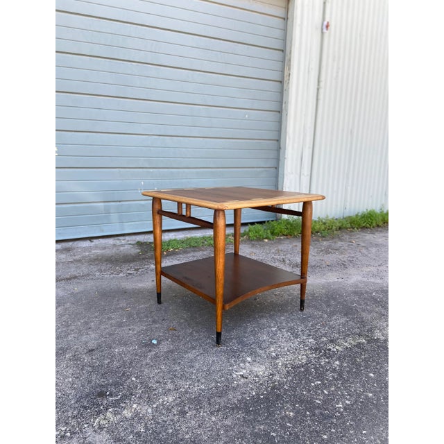 Mid-century modern ‘Acclaim’ square side table with curved lower shelf. By AltaVista Lane Furniture. Classic dovetail...